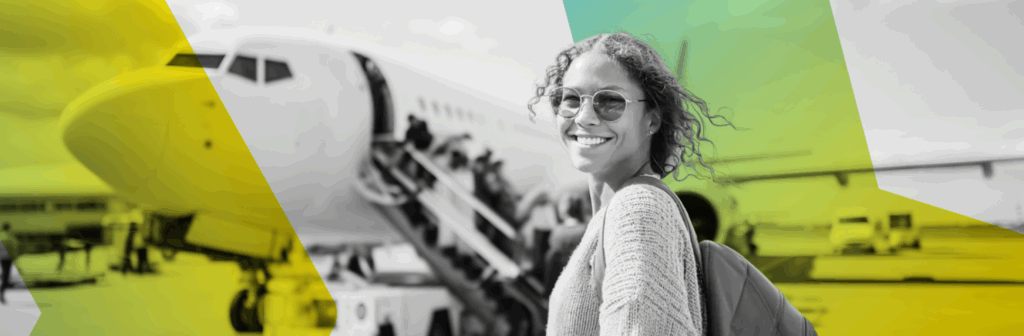 A lady standing in front of a plane she is about to board.